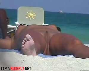 Spanish female sunbathing nude in the beach of island