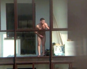Nude stud on the balcony in spy hidden cam vid